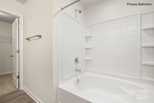 a white bath tub and shower