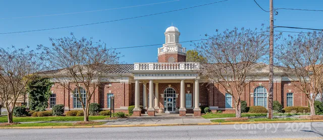 front view of a brick house with a yard