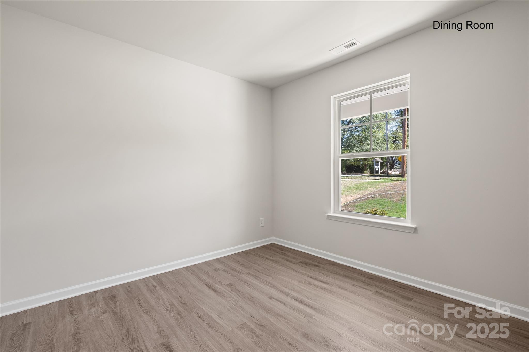 300 Elm Street Lancaster, SC 29720 - Photo 9 of 43 an empty room with wooden floor and windows