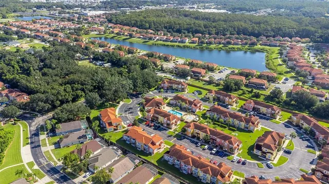 an aerial view of a house with a garden and trees