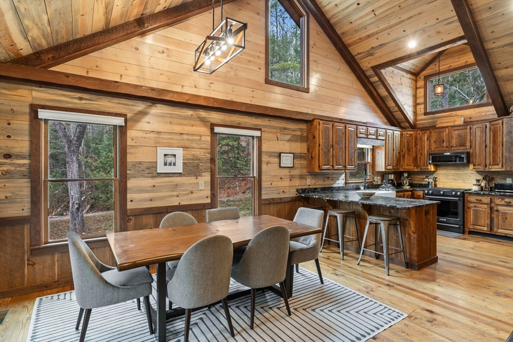 15 Bootleg Mountain Road Morganton, GA 30560 - Photo 14 of 67 a dining room with furniture a rug and wooden floor