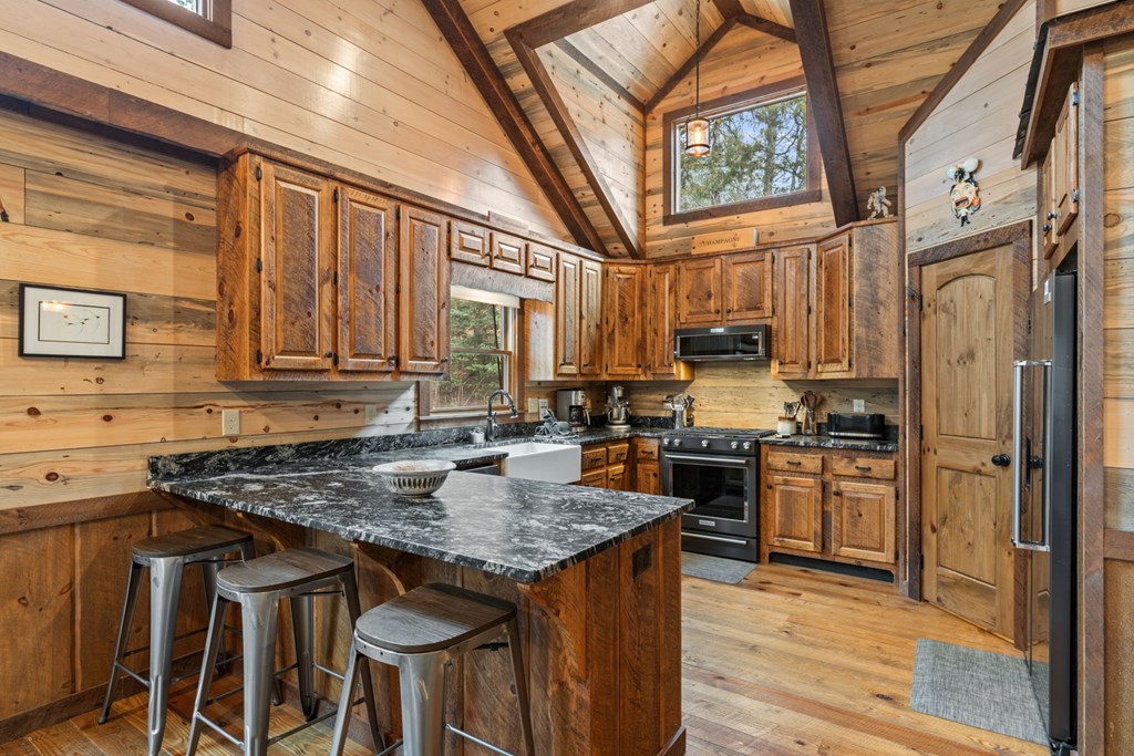 15 Bootleg Mountain Road Morganton, GA 30560 - Photo 16 of 67 a kitchen with stainless steel appliances granite countertop a stove refrigerator sink and cabinets