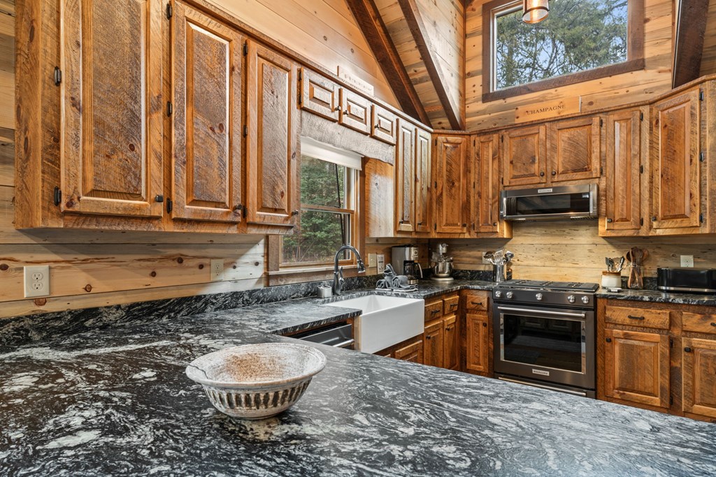15 Bootleg Mountain Road Morganton, GA 30560 - Photo 18 of 67 a kitchen with stainless steel appliances granite countertop a stove a sink and a granite counter tops