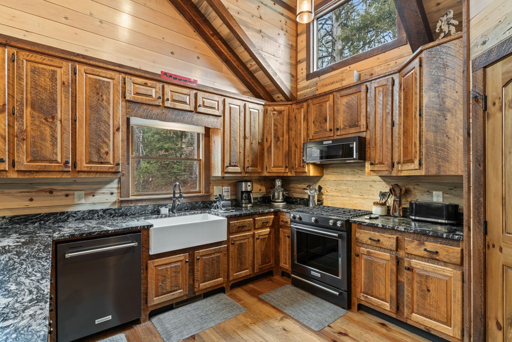 15 Bootleg Mountain Road Morganton, GA 30560 - Photo 19 of 67 a kitchen with stainless steel appliances granite countertop a stove sink microwave and refrigerator