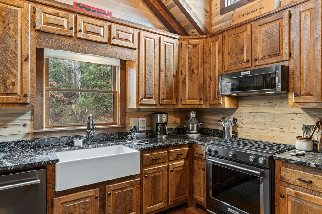 15 Bootleg Mountain Road Morganton, GA 30560 - Photo 20 of 67 a kitchen with stainless steel appliances granite countertop a stove a sink and a microwave