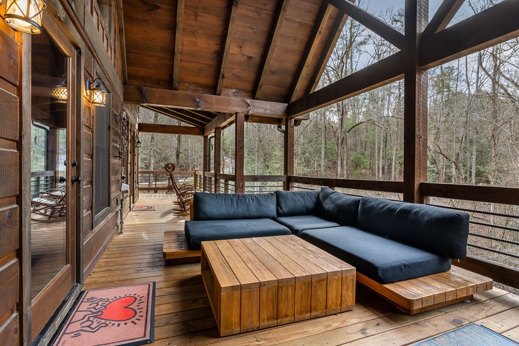 15 Bootleg Mountain Road Morganton, GA 30560 - Photo 22 of 67 a living room with furniture and a floor to ceiling window