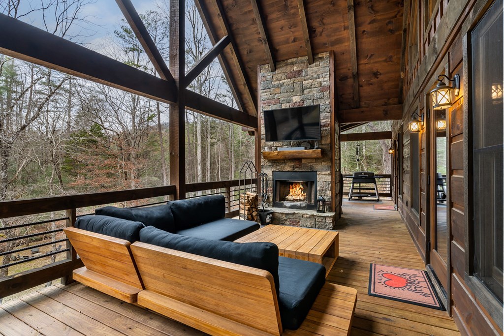 15 Bootleg Mountain Road Morganton, GA 30560 - Photo 24 of 67 a living room with furniture a fireplace and a floor to ceiling window
