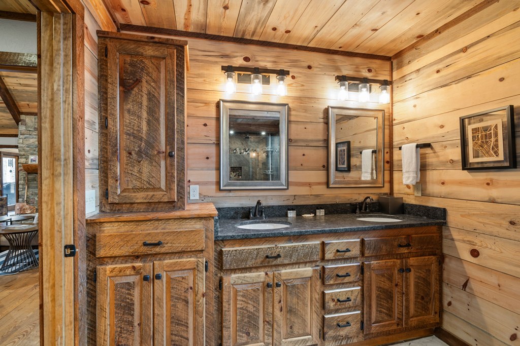 15 Bootleg Mountain Road Morganton, GA 30560 - Photo 31 of 67 a bathroom with a granite countertop sink and a mirror