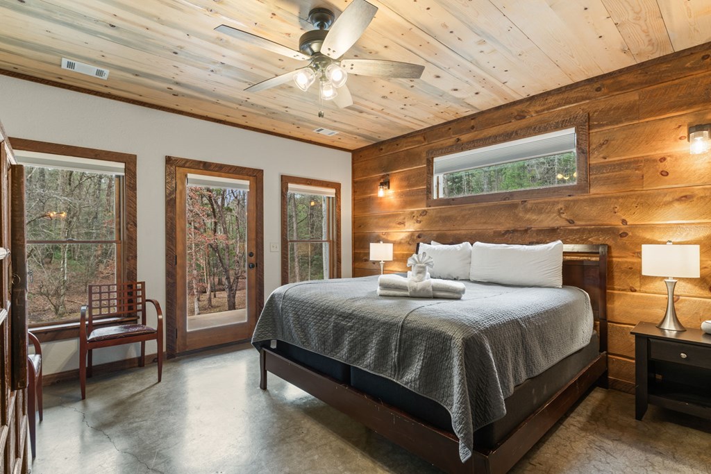 15 Bootleg Mountain Road Morganton, GA 30560 - Photo 40 of 67 a bedroom with a large bed and a chandelier