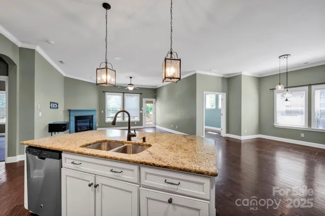 a kitchen with kitchen island a sink stainless steel appliances and cabinets