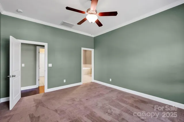 an empty room with closet and fan
