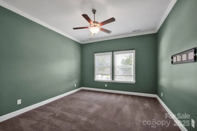 a view of a livingroom with a ceiling fan and window