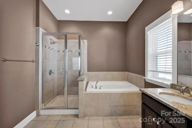 a bathroom with a tub a sink and shower