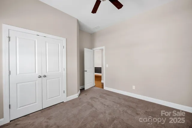 an empty room with ceiling fan