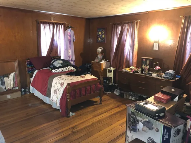 a bedroom with a bed and lamp with window