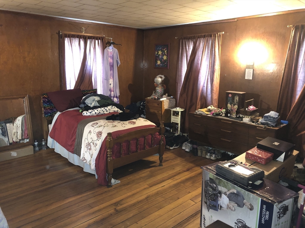 441 Main Street Hardwick, MA 01031 - Photo 11 of 26 a bedroom with a bed and lamp with window