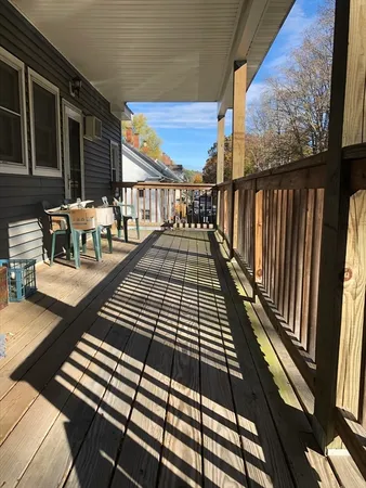 a view of balcony with wooden floor and outdoor seating