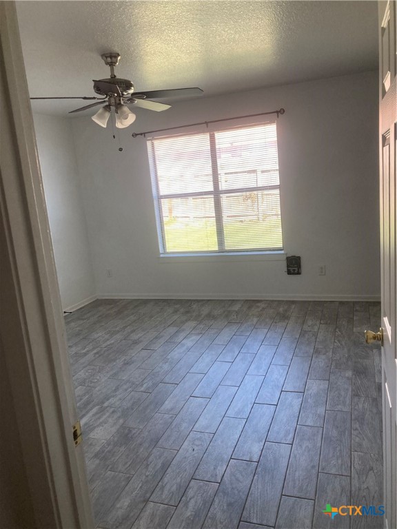 4601 John David Drive Killeen, TX 76549 - Photo 2 of 11 an empty room with wooden floor fan and windows