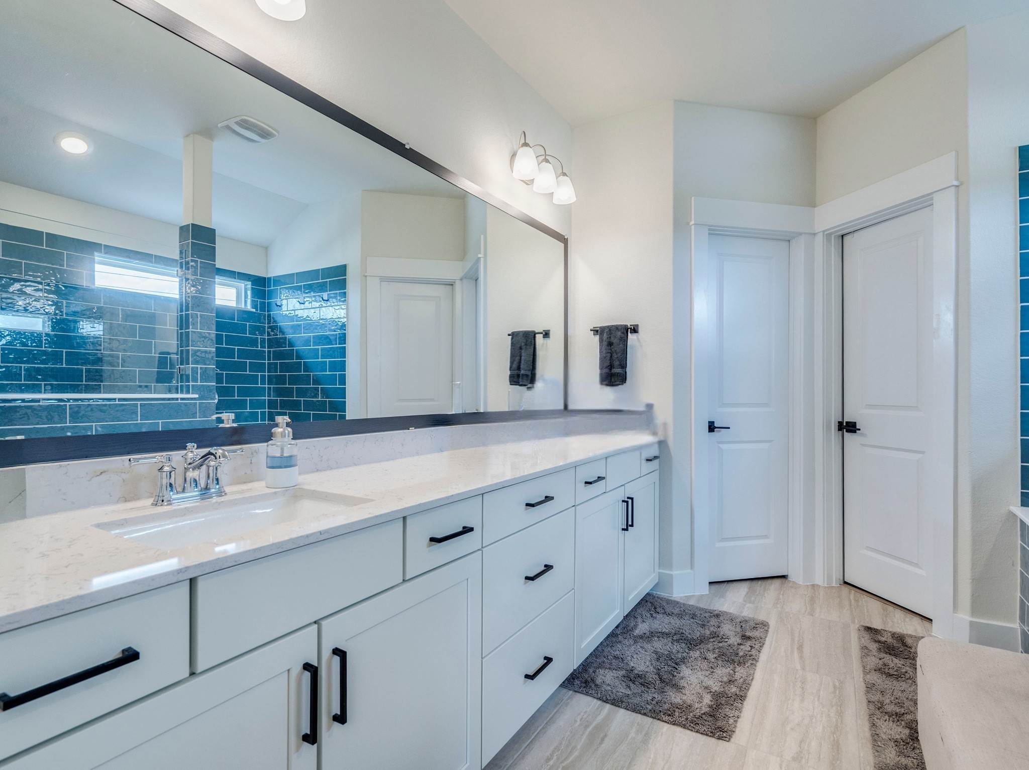 297 Tree Nut Loop Buda, TX 78610 - Photo 15 of 25 Dual vanity, cabinets all designed a like with soft close and hardware. Walk in closet, walk in water room, and expansive mirror and great lighting!