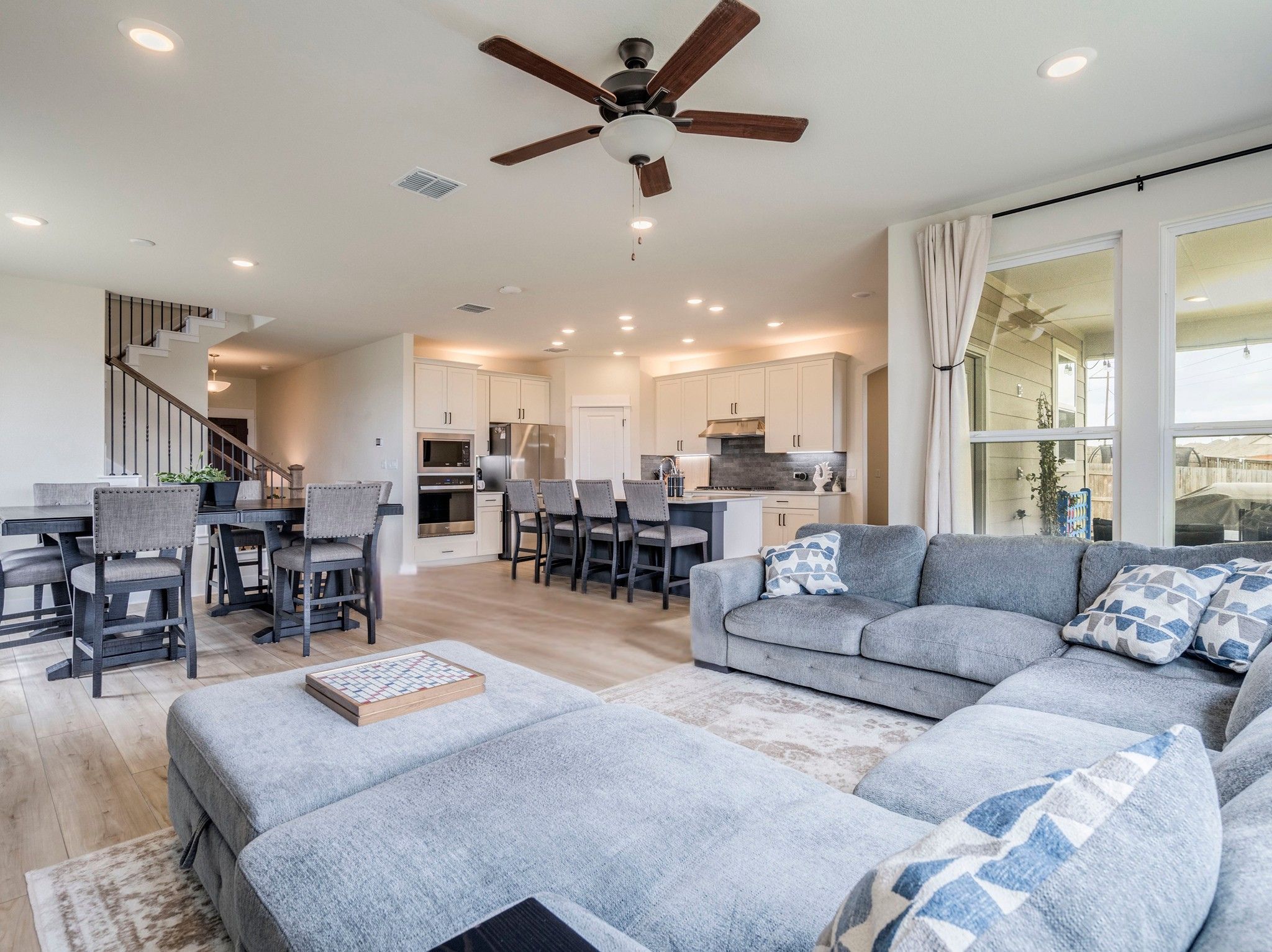 297 Tree Nut Loop Buda, TX 78610 - Photo 10 of 25 Lovely drapes, large living area, recessed lighting, ceiling fan and quick access to extended back patio