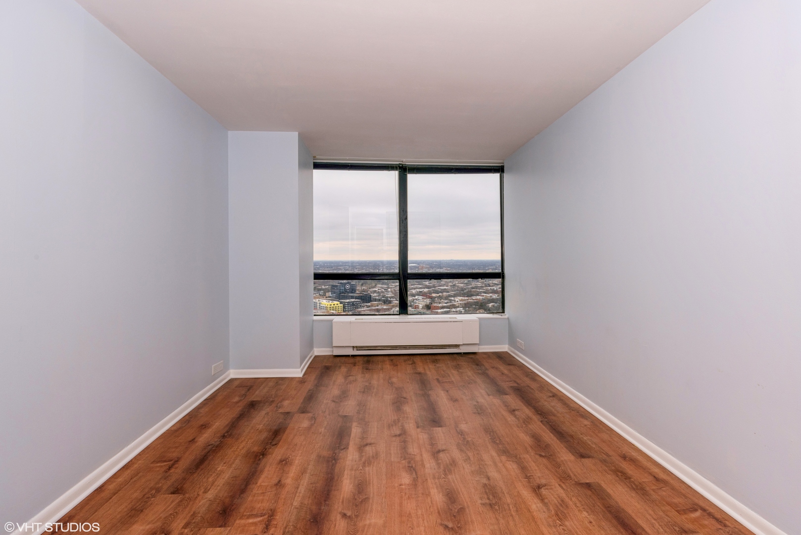 5415 North Sheridan Road, Unit 3814 Chicago, IL 60640 - Photo 11 of 25 a view of a room with wooden floor and a window