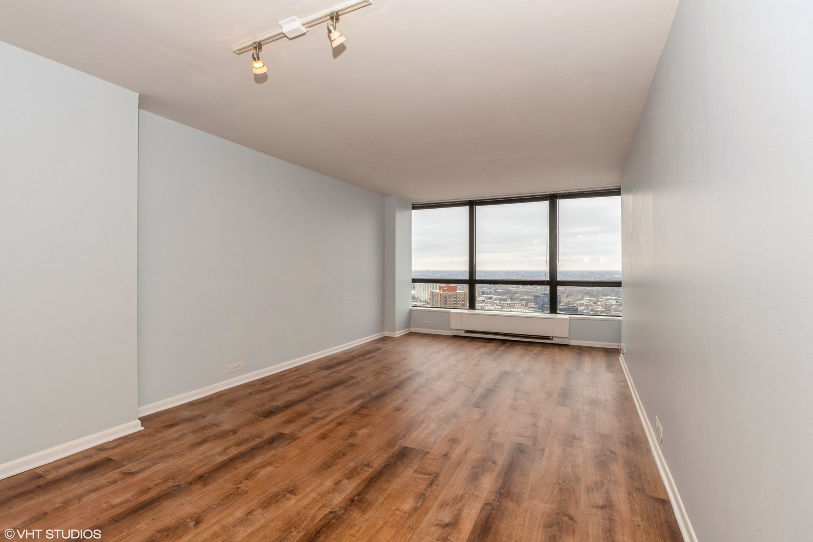 5415 North Sheridan Road, Unit 3814 Chicago, IL 60640 - Photo 5 of 25 wooden floor in an empty room with a window