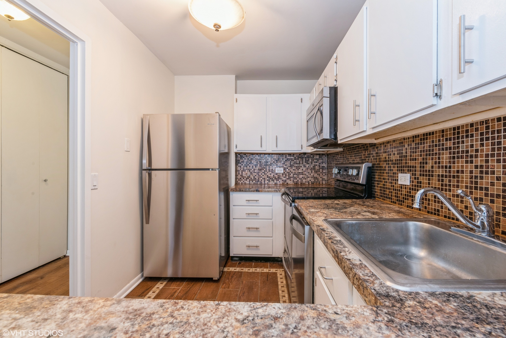 5415 North Sheridan Road, Unit 3814 Chicago, IL 60640 - Photo 10 of 25 a kitchen with a refrigerator sink and cabinets