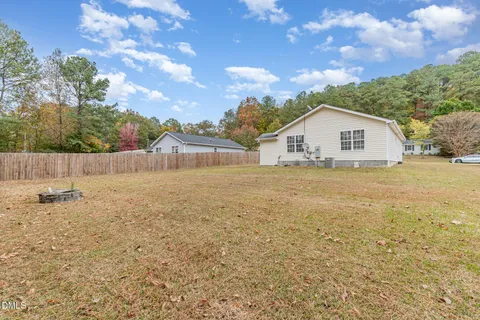 a view of a house with a yard and garage