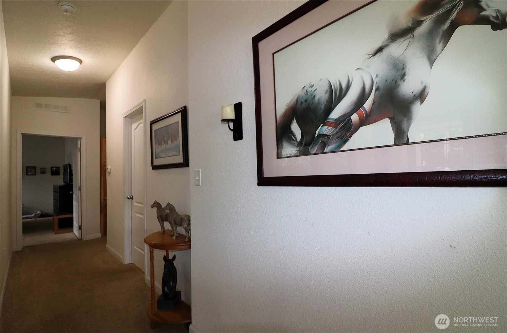 1111 Archwood Drive Southwest, Unit 285 Olympia, WA 98502 - Photo 12 of 17 a view of a hallway with paintings on the wall