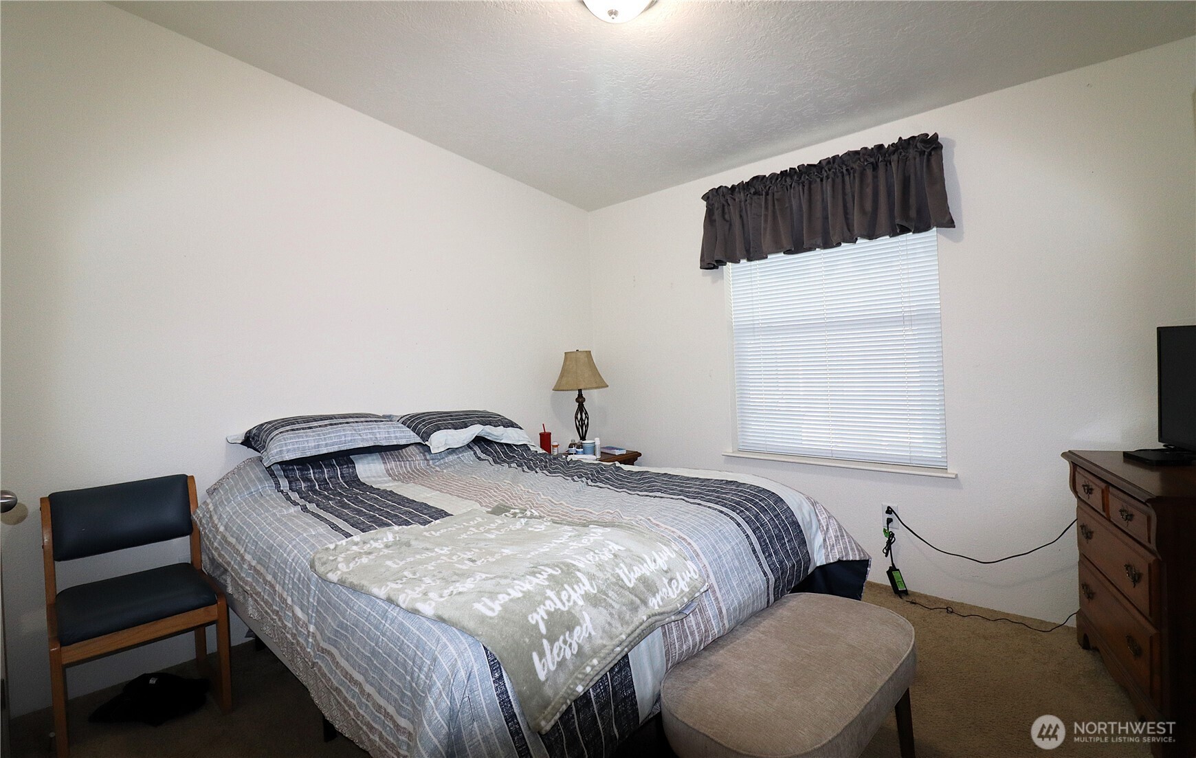1111 Archwood Drive Southwest, Unit 285 Olympia, WA 98502 - Photo 13 of 17 a bedroom with a bed and a window