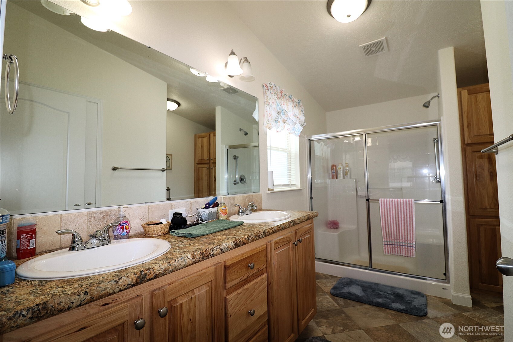 1111 Archwood Drive Southwest, Unit 285 Olympia, WA 98502 - Photo 16 of 17 a bathroom with a granite countertop double vanity sink mirror and shower