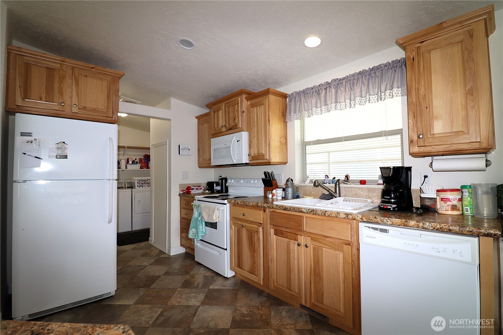 1111 Archwood Drive Southwest, Unit 285 Olympia, WA 98502 - Photo 5 of 17 a kitchen with a refrigerator stove top oven and sink
