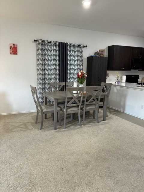 233 Perfect World Loop Jarrell, TX 76537 - Photo 7 of 24 An inviting dining area flows seamlessly into a well-appointed kitchen.