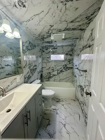 a bathroom with a sink toilet and shower