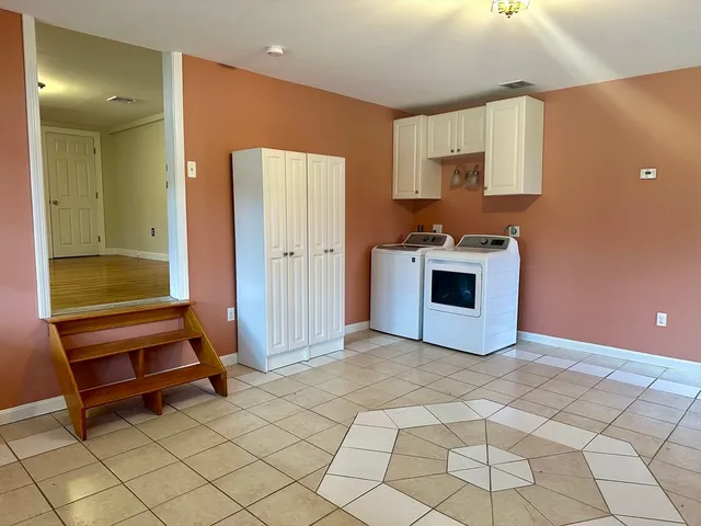 a view of a kitchen with a sink and a refrigerator