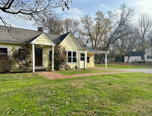 a front view of a house with a garden