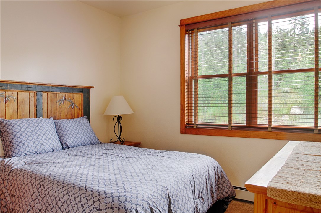 77 Antlers Gulch Road, Unit 304 Keystone, CO 80435 - Photo 12 of 25 Bedroom looking out onto the forest