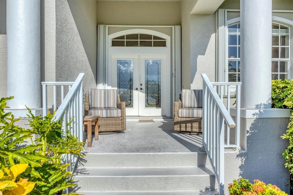 4 Windward Way Placida, FL 33946 - Photo 8 of 39 a view of front door and porch with wooden floor
