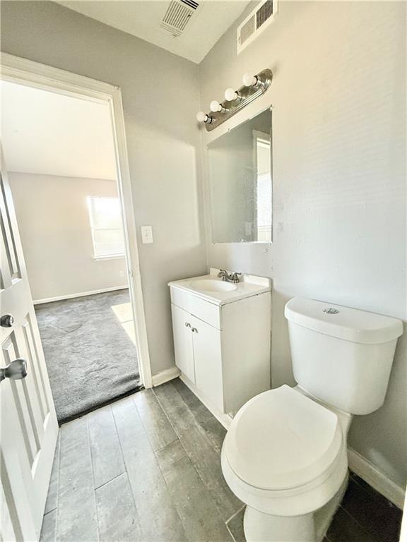 4701 Flat Shoals Road, Unit 2B Union City, GA 30291 - Photo 13 of 14 a bathroom with a toilet sink and mirror