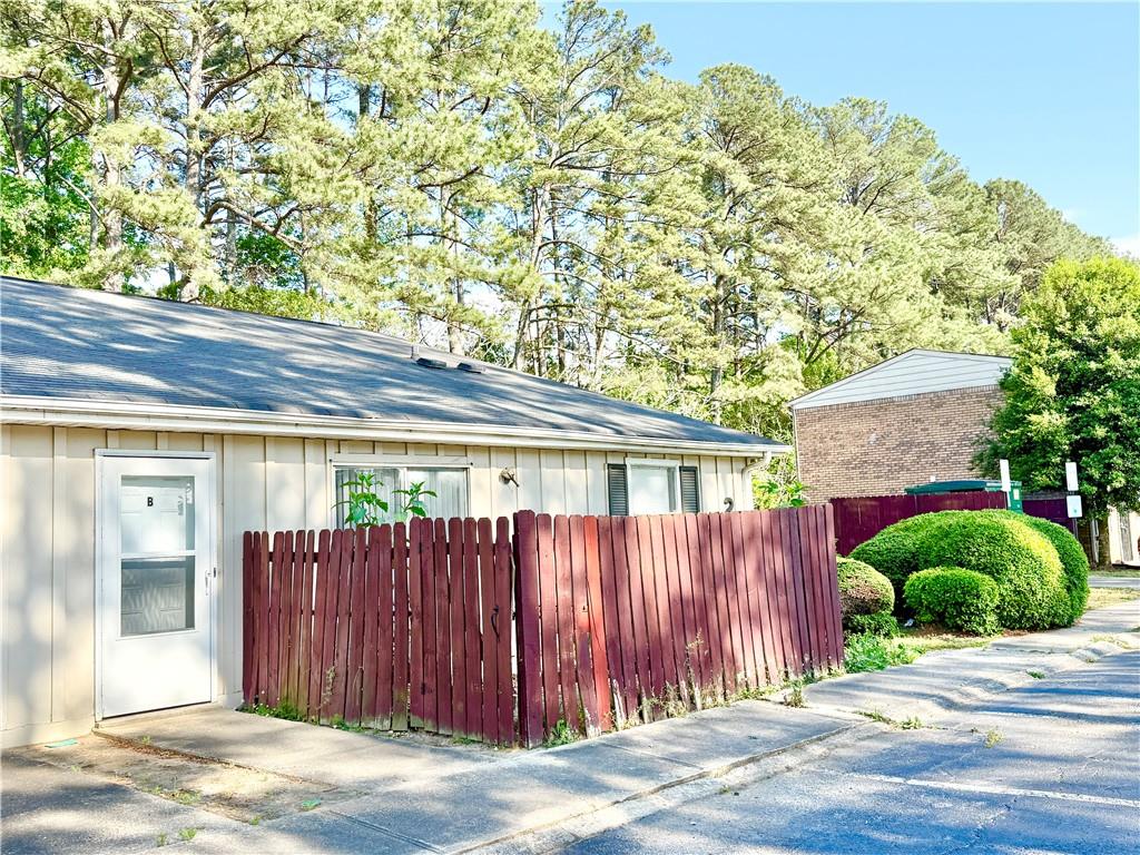 4701 Flat Shoals Road, Unit 2B Union City, GA 30291 - Photo 2 of 14 a view of a house with a backyard space and wooden fence