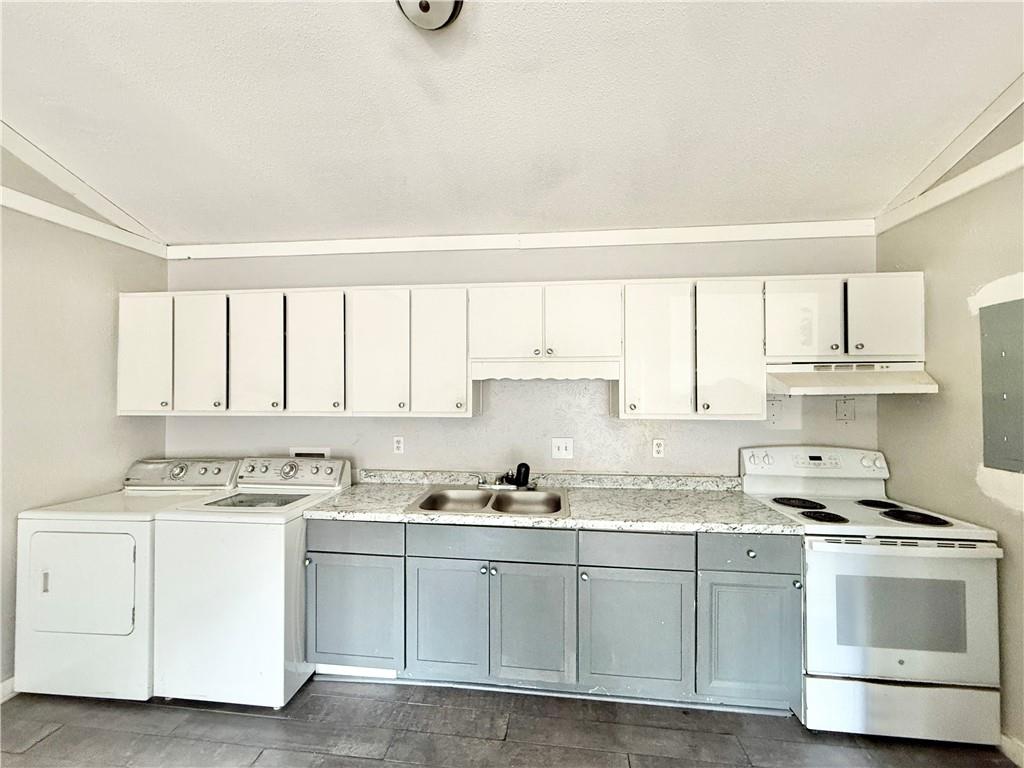 4701 Flat Shoals Road, Unit 2B Union City, GA 30291 - Photo 7 of 14 a kitchen with cabinets appliances a sink and a window