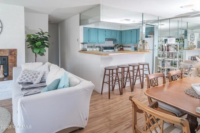 a living room with furniture and kitchen view