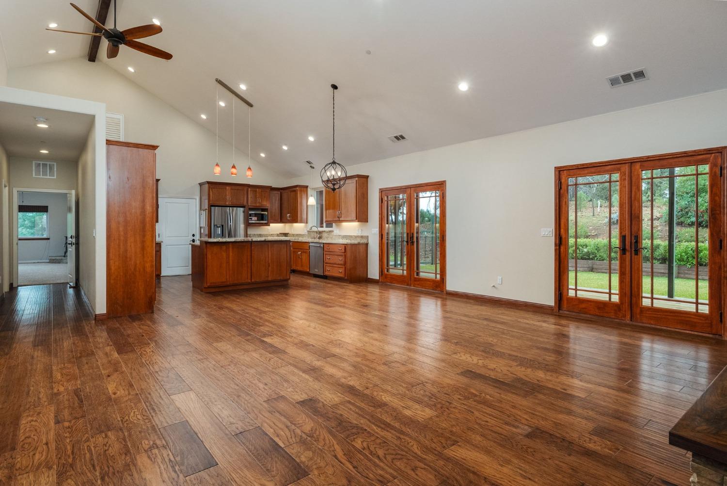 9080 El Dorado Trail Mountain Ranch, CA 95246 - Photo 13 of 44 an empty room with wooden floor and windows