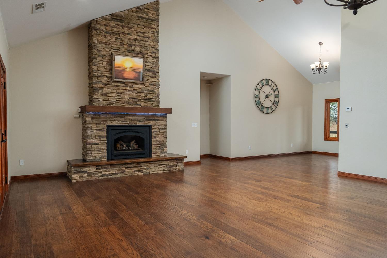 9080 El Dorado Trail Mountain Ranch, CA 95246 - Photo 14 of 44 a view of a livingroom with wooden floor and a fireplace