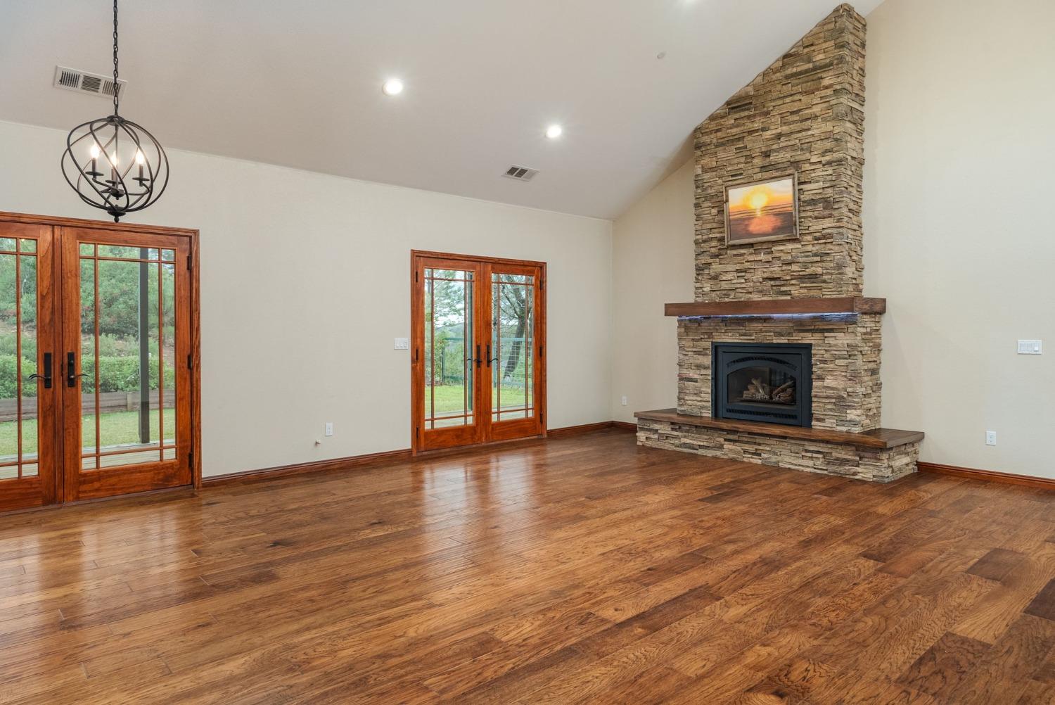 9080 El Dorado Trail Mountain Ranch, CA 95246 - Photo 15 of 44 a view of an empty room with wooden floor and a window