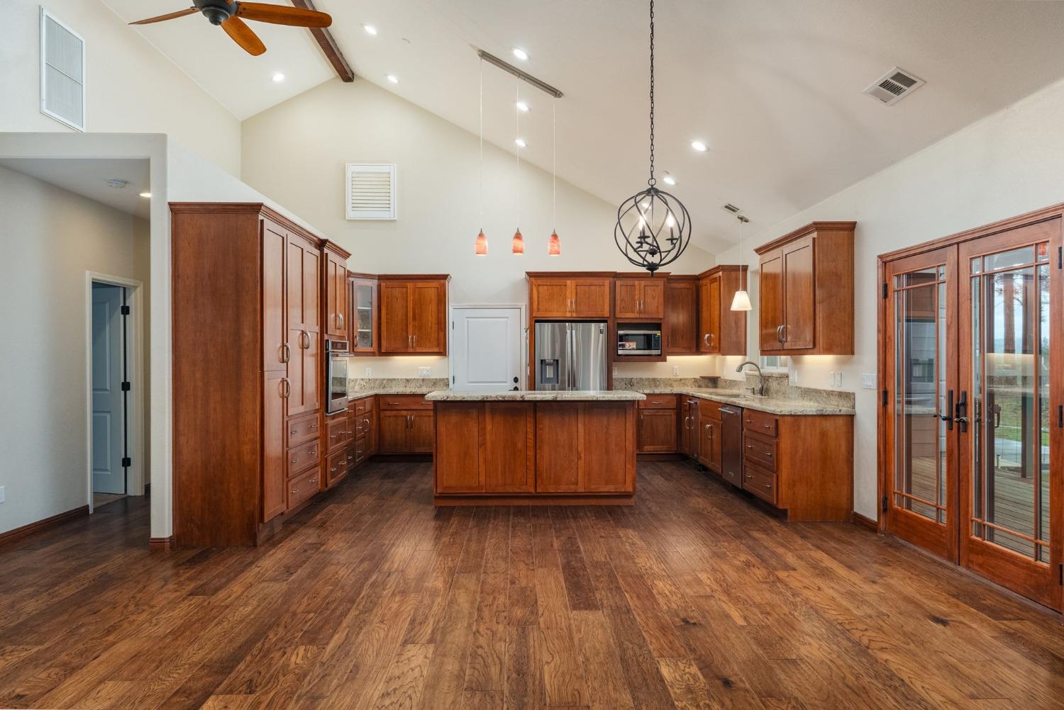 9080 El Dorado Trail Mountain Ranch, CA 95246 - Photo 16 of 44 a large kitchen with lots of counter space a sink and stainless steel appliances
