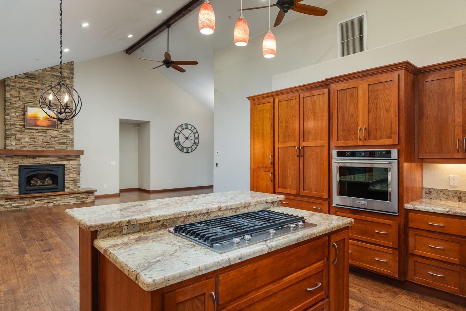 9080 El Dorado Trail Mountain Ranch, CA 95246 - Photo 17 of 44 a kitchen with granite countertop a stove cabinets and stainless steel appliances