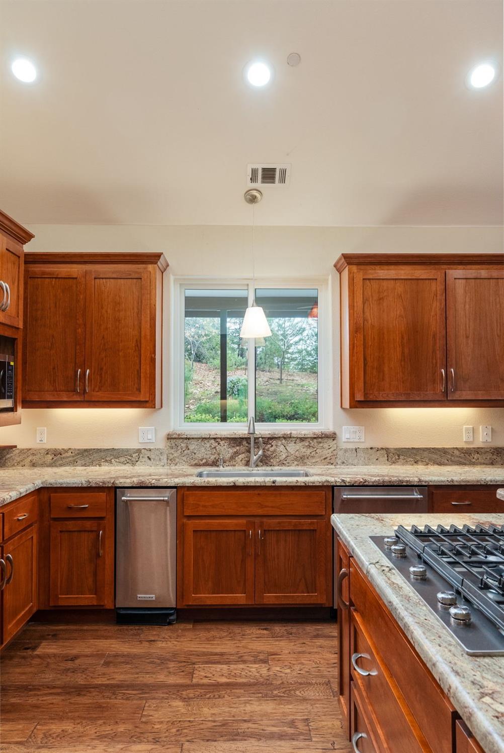 9080 El Dorado Trail Mountain Ranch, CA 95246 - Photo 19 of 44 a kitchen with stainless steel appliances granite countertop a sink stove and refrigerator