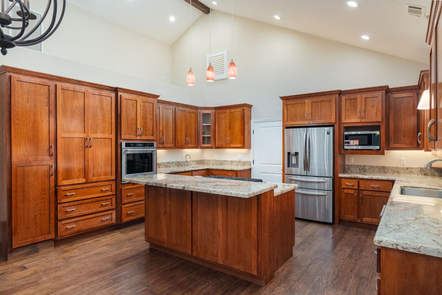 9080 El Dorado Trail Mountain Ranch, CA 95246 - Photo 21 of 44 a kitchen with stainless steel appliances granite countertop a refrigerator a stove and a sink