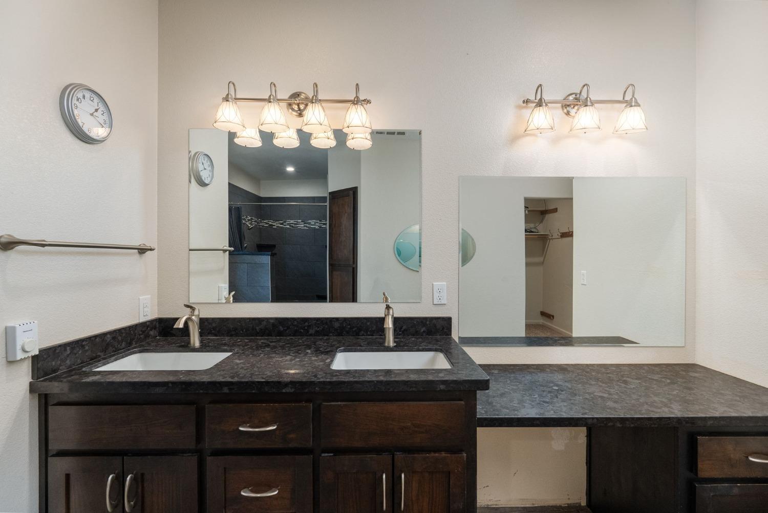 9080 El Dorado Trail Mountain Ranch, CA 95246 - Photo 26 of 44 a bathroom with a granite countertop sink a mirror and vanity